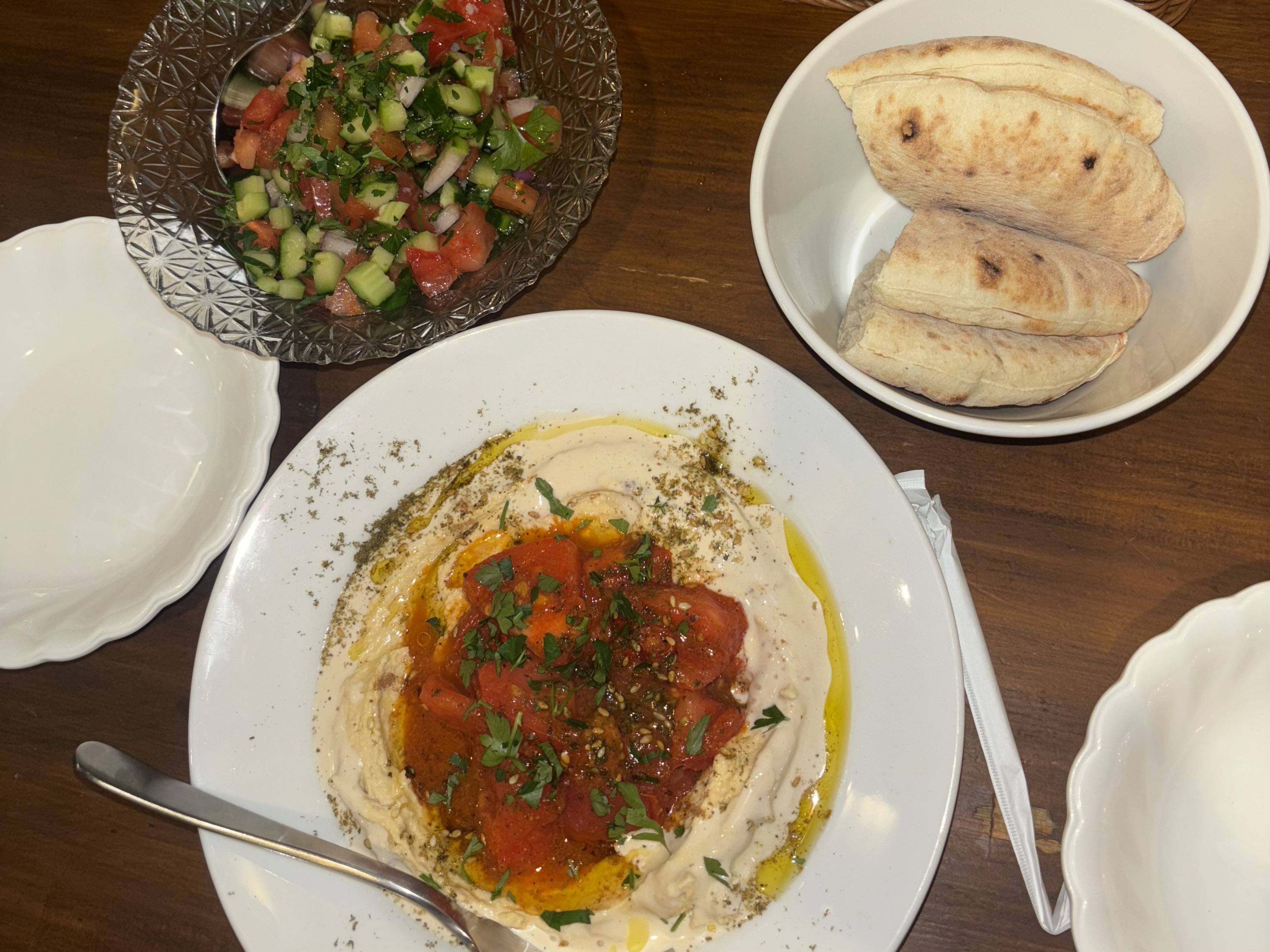 Israeli-style hummus with tomato, olive oil and za'atar — served in Tokyo with fresh pita