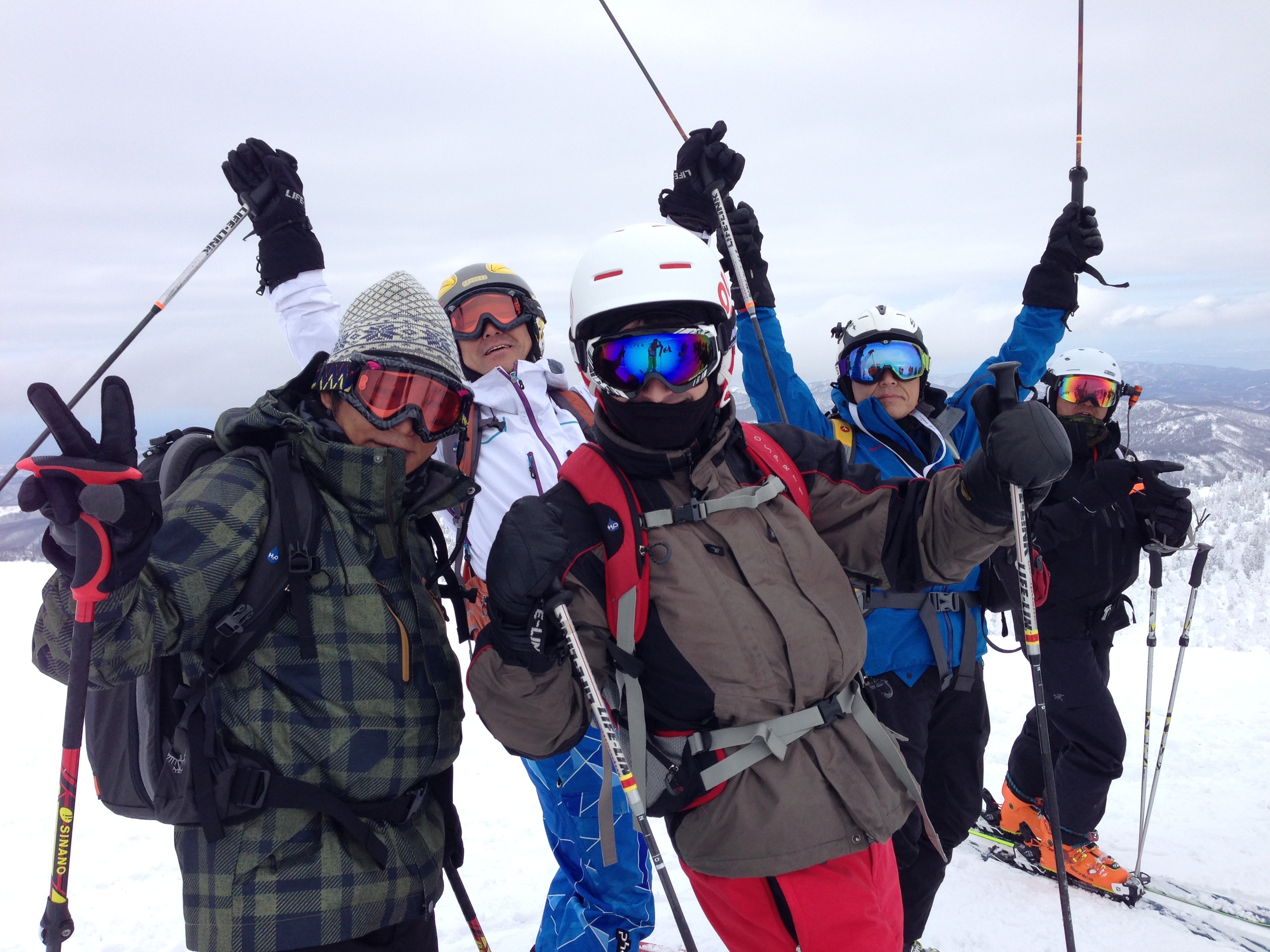 Evan with a ski group at the top of a mountain in Japan