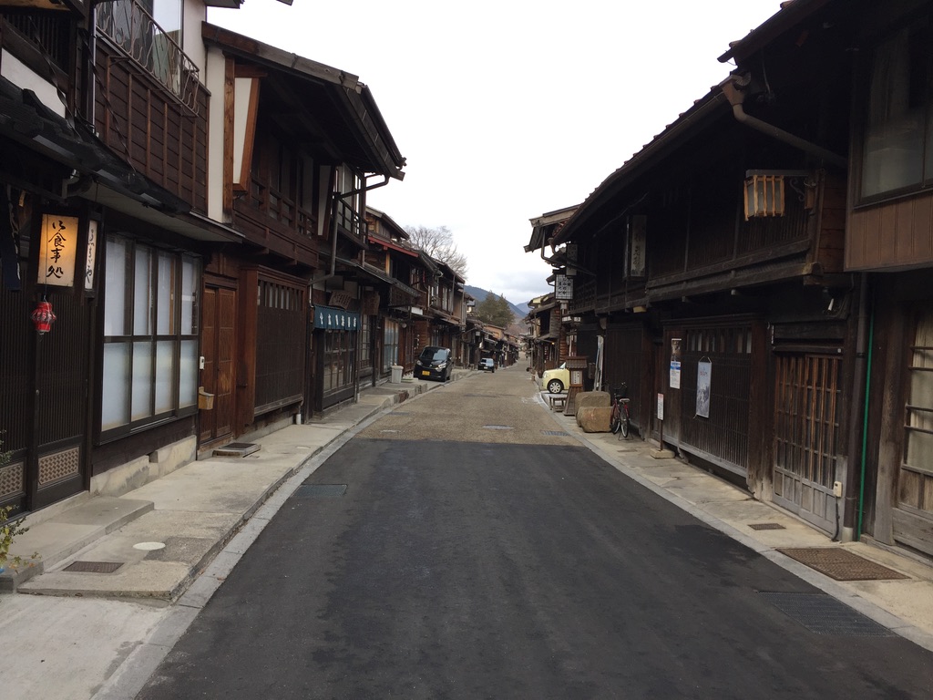 Historic Nakasendo post town street with traditional wooden architecture, Japanese Alps